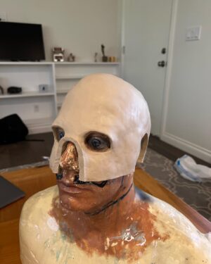 Wes Borland Instagram - This was the development process for the new stage look. From first sketch to sculpting and molding/casting/painting/grinding etc. @aliejoboxblock really helped me out on this one with pivoting to solve problems and come up with new solutions/ be a sounding board. I had the buffalo teeth to make the entire lower portion of the helmet but Japan and New Zealand have laws on importing animal products, so I cast 250 buffalo teeth out of resin which ended up being a plus because the material is lighter. The last photo is me repainting a new jacket today in Auckland because the fabric markers I used bled with sweat and were a complete fail. I don’t usually show the process this much but there have been questions about this one in particular so here ya go. Also shout out to @adelemildred for throwing me some advice from across the pond. Cheers!