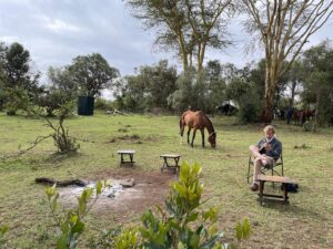 William H. Macy Instagram - Our routine was to get up early (5:30 or 6:00) and have a coffee. After our morning ride we’d have a huge sumptuous breakfast. The staff would fill two basins of hot water, which sat on tripods outside our tents so we could wash our faces.  Our horses were already tacked up and our morning ride would begin at about 7:00.  Our rides would last two to three hours.  Simon led our party and Daisy or Rosie would take the rear.  Simon carried a bullwhip which he could make sound like a gun shot. The first morning, as the trail led us through tall brush on both sides, Simon called back that if anything rushed us, we should turn our horse and go back the way we came with “some dispatch”. Now to me, that raised a lot of questions, but everyone just nodded and kept riding so I did too.
 
Felicity and her brother had ridden across the Maasai Mara on previous safaris, but we were in Laikipia, which is the hill country in north west Kenya.  We would cross great plains and then climb into the hills which gave us some breathtaking views. Simon and our Maasai guide, Netti, were astounding in their ability to spot game, and they had encyclopedic knowledge of everything we saw.  Simon would suddenly shout “Fish Eagle!”. And I would stare at a black lump in an Acacia tree wondering if I was looking in the right place, and then this monstrous bird, which looks a lot like our Bald Eagles, would open his massive wings and glide effortlessly over us.  Or Simon would reign his horse and whisper, “elephants”. And I would scour the bush not seeing any elephants. Until one moved.  And then I’d see seven elephants.  And they are big.  I mean really big.  Even the little ones are big. I feel stupid saying elephants are big – we’ve all been to the zoo, but when you’re in the cage with them, they get a lot bigger.  They are such improbable animals with their kind wise faces and their adorable giant babies, that you have to remind yourself they kill a lot of people every year.  Cape buffalo kill even more people and we saw a lot of them too.  But because there were twelve of us on horseback, and Simon had his bullwhip, I didn’t ever feel we were in real danger.  Then we saw the lions.