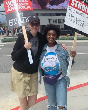 Yaani King Mondschein Instagram - Joined the picket line at Universal yesterday with my dear friend and incredible writer @marlanahope. There are stacks of signs you can choose from that other writers have made in weeks past, and we found this one that read “You haven’t seen THE LAST OF US!”! It felt divinely inspired. 😉 Met some wonderful people and had some really great conversations. Solidarity takes many forms and I’m looking forward to continue showing mine in any way I can. We really are stronger together. 
#SAGAFTRAstrong #WGAstrong #1u