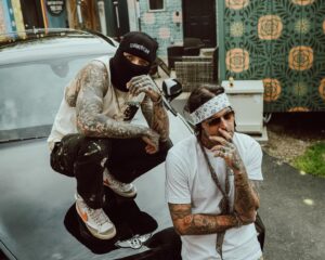 Yelawolf Instagram - for the record I’m the only sum’bitch bout to rock my lil bro’s chain @caskey … besides that he took care of his invoices !! hit @slumerican for all the new duds we’re rockin !!!! Caskey is here in Nashville dropping a new album coming out on SLUMERICAN !!!! @wlpwr myself and @mikedhartnett in here producing smashes !! next level shit !!!! LOVE YALL !!! 🎥 : @mikeoryanlane #slumerican 2024 !!