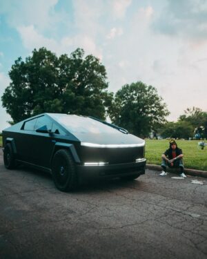 Yelawolf Instagram - sittin on the tail gate of a different kinda box these days .. @teslamotors Foundation Series Cyber Truck .. aye you can’t have War Story without a fighter jet in the drive way .. that black on black SLUMERICAN stealth bomber … I named her Temples Chariot !!!! CARS CARS FANCY CARS !!!! 🎥 @visualsbytyre #slumerican #tesla #cybertruck