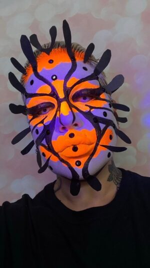 Yvonne MacInnis Instagram - Fun fact🤡🐠Clown fish are born with both genders and can change later in life. I think us humxns can learn a lot from these little underwater cuties. 🐠

If we were freed from gender constraints, maybe we would live in a world where the art of makeup would be for everyone - free of oppressive and unhealthy beauty standards and other salty creatures opinions about what womxn and mxn should “look” like #clownfish #feminist #nonbinary 🤡 🐠 

My look 1 from @paintedwithraven season finale.. check it out now on @wowpresentsplus @worldofwonder 

#makeupartist #creativemakeup #creativemakeuplooks #artistry #avantgarde #neonmakeup #uvmakeup #bioluminescence