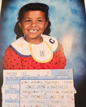 Adrienne Warren Instagram - My dad reminded me Once Upon a Mattress (which just so happens to be coming back to Broadway this year!) was the first show I ever saw. 
I sat on my mother’s lap, pointed at the stage and said.. “I wanna do that!” 
Life was never the same. 
Thank you to my parents for listening and doing whatever they could to nurture that seed. 

Also… these BANGS. 😝