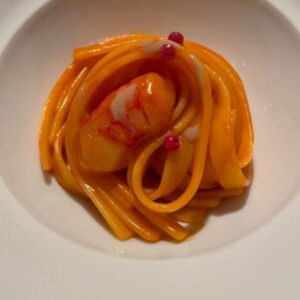 Aiste Miseviciute Instagram - Niko Romito @nikoromito, a self-taught chef from Abruzzo, never expected cooking to become his passion. He studied economics in Rome to become a finance advisor, but his life changed when his father fell ill after converting their family pastry shop, Reale @ristorantereale , into a trattoria. Niko and his sister Cristiana @cristianaromito returned to Abruzzo to manage the trattoria, intending to sell it. However, they grew to love the culinary world, and after their father's passing, they chose to take over the business.
Despite lacking formal training in the culinary arts, Niko rapidly developed a distinctive style of cooking and earned his first Michelin star within just seven years. In 2011, he and Cristiana relocated their restaurant to Casadonna, a 16th-century former monastery located in Castel di Sangro. 
I've had a chance to taste Niko's cuisine before at the Bulgari hotels in Paris and Rome, but cooking at Reale is nothing like the classic Italian dishes served there. The cuisine style at Reale is highly personal, original, and not necessarily aimed at pleasing everyone. At Reale, Chef Niko elevates "cucina povera" and simple ingredients to new heights. It's a style of cooking that invites you to reflect while remaining delicious in its own right.

Some highlights from the dinner...

- Fettuccelle with red prawns and pink pepper
- "Carrot" - a single ingredient dish consisting of carrot caramel, carrot purée, sweet and sour carrot juice, and marinated carrots. 
- Roasted cuttlefish and pink pepper was one of my favourite dishes of the evening.
- Watermelon and tomato with tarragon, thyme, a bit of salt and olive oil. 
- Onion reduction (made without any water), parmigiano buttons and toasted saffron. 
- Lentils,hazelnut ard garlic - lentil jelly, hazelnut emulsion and crunchy Santo Stefano di Sessanio lentils. 
- Barbecued, oxidated and brined Swiss chard salad, served with reduced cream of Swiss chard and seasoned with ginger, bay leaf extract and oil of sweet and chili pepper.
- Eel, lemon, roasted garlic and chilli pepper
- Roasted endive with very thin coat of crispy potato
- Meringue, raspberry and caramel