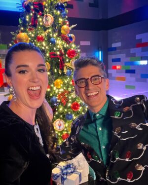 Amy Corbett Instagram - Behind the scenes photodump from @legomastersfox Celeb Holiday Bricktacular 🎄🎅🌟
Have you watched yet? If not, what are you waiting for??? Find it on Hulu 🤩Also…how awesome is all the brick built scenery on set!?! Thought you might like a closer look 🙌
📸 Getting my elf on - comfy slippers and clipped up curls 😂
📸 Brickbuilt fireplace 
📸This teddy bear was a personal fave 
📸Beautifully crafted sleigh 
📸Brickmaster having a blast on set
📸Family photos on the mantelpiece 😂
.
.
.
#legomasters #legomastersfox #legomastersusa #lego #legobuild #holidaybricktacular #celeb #build #play #legobuilders #afol #christmas #christmasspecial #holidayspecial