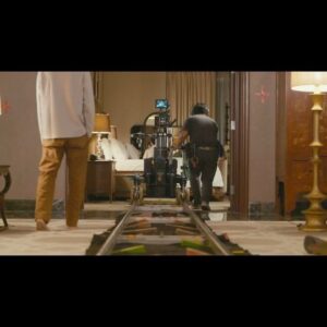 Angga Dwimas Sasongko Instagram - Shot ini saya design sebagai titik tengah timeline cerita @heartbreakmotelfilm. Ava bertemu dengan Raisa dan Maya. Ada cermin dengan tiga refleksi. Pertanyaannya; bagaimana crafting shot dan adegannya pada peristiwa sepenting ini? Bagaimana menggambarkan loneliness feeling dari @laurabas tanpa membuat dirinya dieksploitasi?

Saya ingin mengajak penonton mendekat ke perasaan yang dibangun Laura dalam satu tarikan nafas panjang, menikmati ruang dan waktu Ava tapi juga memberikan nuansa yang grandeur juga suspenseful dalam sebuah kamar hotel.

Masalahnya; ruangan hotel bukan bangunan studio yang partisi dindingnya bisa diubah. Motion control atau techno crane untuk membuat camera seperti floating di dalam ruangan tidak bisa masuk ke kamar. Bagaimana dengan refleksi kamera di cermin? Bagaimana dengan furniture di foreground? 

Butuh jadi cerdik ketimbang menyerah sama situasi. Saya putuskan untuk membuat shot itu dengan teknik seamless cut dengan mengakali velocity kecepatan track in kamera memakai bantuan metronome. Dengan dukungan 3 warna lakban dan 3 potong track, shot ini diakali dan ternyata berhasil!

Premise-nya, cara low tech untuk bikin high tech shot 😁
