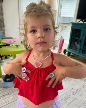 Anthony Carelli Instagram - Melina Rose is showing off some costume jewellery that her big sister @ariannagrace_wwe got her for her birthday, but it looks like she’s throwing up gang signs lol
