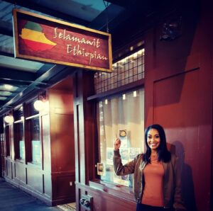 Azie Tesfai Instagram - My mom immigrated to this country with nothing. Her life long dream was to open her own Ethiopian restaurant, but instead she sacrificed everything to give me every possible opportunity. So in my first tv writing episode, in the opening scene my character walks out of an Ethiopian restaurant for an important call. An Ethiopian restaurant with my mom’s name on it. Selamawit Ethiopian. 
Love you mom. Honoring you, in putting a bit of your dream into the sacrifices you made so I could have my own ❤️❤️❤️