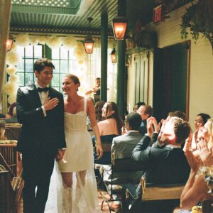 Barton Cowperthwaite Instagram - We were married in the Solarium next to the Piano Bar at the Hotel Chelsea. Choosing the Chelsea was an easy decision. It’s iconic, filled with art and history. I grew up on 22nd between 5th and 6th, and remember it in its late 90’s crumbling glory. The Solarium, small and perfect for our 35 guests, has a beautiful skylight running the length of the room. Decorated with plants and greenery, it was perfect as it was, requiring minimal decoration.

Our best friend Sammy (Bart’s best friend since birth) who knows us as individuals and as a couple better than anyone else, officiated the ceremony. It felt comfortable, relaxed, and unfussy. Our violinist played as we each walked down the aisle with our parents. The three of us stood in front of an arch I constructed from wooden dowels, tissue paper flowers from Etsy, Velcro, and hot glue. We were flanked by two bunches of my favorite Allium flowers. We each took a long moment to take in the space before our vows. We wanted to be as present as possible. 

After the ceremony, we had a champagne toast, and Bart’s brothers each said a few words. Our guests stayed for a cocktail hour while we left to do photos in our room. We left the Hotel Chelsea and went to the West Village with our photographers. Standing on a corner next to a tipped-over trash can for 15 minutes, trying to hail a cab, we were met with honks and cheers. It was a quintessential New York moment, a reminder that the city stops for no one.

We walked around the West Village, taking photos at all our favorite neighborhood spots. We stopped by Grove Apothecary to see our pharmacists, who have always taken such good care of us. We visited the Jane laundromat, where Bart has made friends with everyone who works there. We were all heartbroken when he got sick, but no one was as crushed as our friends at the laundromat. We dropped in at Casa Magazines, where Bart buys copies of the magazines he’s published in. This community is a part of our everyday lives. They’ve made our New York City feel like a close knit small town. Their kindness and care got us to the other side of a terrifying time, and we wanted to share a piece of the other side with them.