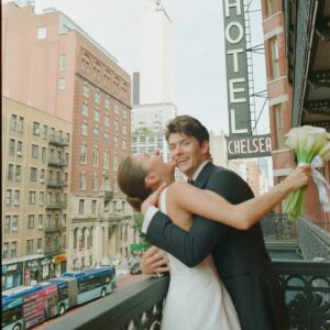 Barton Cowperthwaite Instagram - We were married in the Solarium next to the Piano Bar at the Hotel Chelsea. Choosing the Chelsea was an easy decision. It’s iconic, filled with art and history. I grew up on 22nd between 5th and 6th, and remember it in its late 90’s crumbling glory. The Solarium, small and perfect for our 35 guests, has a beautiful skylight running the length of the room. Decorated with plants and greenery, it was perfect as it was, requiring minimal decoration.

Our best friend Sammy (Bart’s best friend since birth) who knows us as individuals and as a couple better than anyone else, officiated the ceremony. It felt comfortable, relaxed, and unfussy. Our violinist played as we each walked down the aisle with our parents. The three of us stood in front of an arch I constructed from wooden dowels, tissue paper flowers from Etsy, Velcro, and hot glue. We were flanked by two bunches of my favorite Allium flowers. We each took a long moment to take in the space before our vows. We wanted to be as present as possible. 

After the ceremony, we had a champagne toast, and Bart’s brothers each said a few words. Our guests stayed for a cocktail hour while we left to do photos in our room. We left the Hotel Chelsea and went to the West Village with our photographers. Standing on a corner next to a tipped-over trash can for 15 minutes, trying to hail a cab, we were met with honks and cheers. It was a quintessential New York moment, a reminder that the city stops for no one.

We walked around the West Village, taking photos at all our favorite neighborhood spots. We stopped by Grove Apothecary to see our pharmacists, who have always taken such good care of us. We visited the Jane laundromat, where Bart has made friends with everyone who works there. We were all heartbroken when he got sick, but no one was as crushed as our friends at the laundromat. We dropped in at Casa Magazines, where Bart buys copies of the magazines he’s published in. This community is a part of our everyday lives. They’ve made our New York City feel like a close knit small town. Their kindness and care got us to the other side of a terrifying time, and we wanted to share a piece of the other side with them.