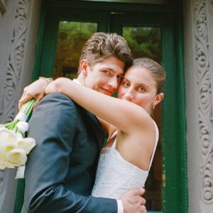 Barton Cowperthwaite Instagram - We were married in the Solarium next to the Piano Bar at the Hotel Chelsea. Choosing the Chelsea was an easy decision. It’s iconic, filled with art and history. I grew up on 22nd between 5th and 6th, and remember it in its late 90’s crumbling glory. The Solarium, small and perfect for our 35 guests, has a beautiful skylight running the length of the room. Decorated with plants and greenery, it was perfect as it was, requiring minimal decoration.

Our best friend Sammy (Bart’s best friend since birth) who knows us as individuals and as a couple better than anyone else, officiated the ceremony. It felt comfortable, relaxed, and unfussy. Our violinist played as we each walked down the aisle with our parents. The three of us stood in front of an arch I constructed from wooden dowels, tissue paper flowers from Etsy, Velcro, and hot glue. We were flanked by two bunches of my favorite Allium flowers. We each took a long moment to take in the space before our vows. We wanted to be as present as possible. 

After the ceremony, we had a champagne toast, and Bart’s brothers each said a few words. Our guests stayed for a cocktail hour while we left to do photos in our room. We left the Hotel Chelsea and went to the West Village with our photographers. Standing on a corner next to a tipped-over trash can for 15 minutes, trying to hail a cab, we were met with honks and cheers. It was a quintessential New York moment, a reminder that the city stops for no one.

We walked around the West Village, taking photos at all our favorite neighborhood spots. We stopped by Grove Apothecary to see our pharmacists, who have always taken such good care of us. We visited the Jane laundromat, where Bart has made friends with everyone who works there. We were all heartbroken when he got sick, but no one was as crushed as our friends at the laundromat. We dropped in at Casa Magazines, where Bart buys copies of the magazines he’s published in. This community is a part of our everyday lives. They’ve made our New York City feel like a close knit small town. Their kindness and care got us to the other side of a terrifying time, and we wanted to share a piece of the other side with them.