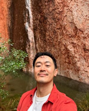 Benjamin Law Instagram - 24 HOURS IN ULUṞU

Shot this lil’ segment in beautiful Aṉangu Country after a rare evening of rain. It meant we could see the true black shade of the monolith under its red rust foundation, and how freshwater gathers at the base of the structure – which is taller than the Eiffel Tower, more ancient than the first dinosaurs and runs another 2.5km underneath.

Thanks to Uncle Sammy Wilson – son of Paddy Uluṟu! – for welcoming and handpicking bush tomatoes for us (an unexpectedly perfect mix of tomato and banana), and this dream team crew of the two Dans, Pariss, Bruno, Sarah and Toby. 

And, of course, icon Julia Zemiro who can do no wrong and for whom I would walk directly into peak hour traffic with my eyes closed if she asked. 

On yr TVs soon. Palya, peeps. ✌🏿✌️✌🏼