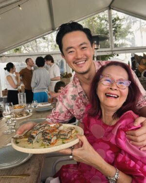 Benjamin Law Instagram - Everyone give it up for the Greatest of All Time who turns 70 (?!) today! 🎂

Blessed to have inherited even an ounce of this woman’s resilience (we’re talking single mother of five kids boss-level resilience), humour, feminism, fashion sense, hectic spice-tolerance and science-defying skin. 

Say something nice about Jenny in the comments and make her day. 

LOVE YOU, BUM. 😘