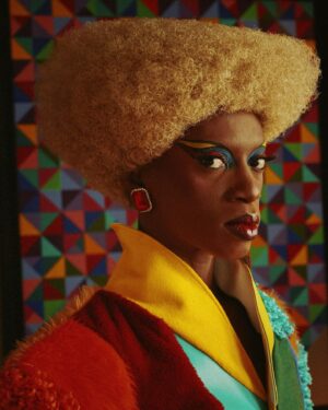 Black Peppa Instagram - BTS shots before heading to @frolovheart SHOW. Thank you @thelondoner 💖

LFW- LOOK 4- Wearing custom @christopherniari to attend the @frolovheart SHOW. Had this concepts for months where I’d use various fabrics with different textures particularly bathroom rugs, felt, suede, faux leathers and furs to create a groovy tailored high waisted pants suit. For this LFW it was also my priority to showcase more black hair styles and desired to style a blonde Afro myself. This was the first time I’ve styled any wig and was quite proud of the end result I must say.

Photographer: @kimlangstudio 
MUA: @jackoliverx using @theunseenbeauty 
Full look: @christopherniari 
Hair by me
Earrings: @nobasicbombshell
Money Nails by @nailsanthonys