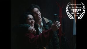 Brenna D'Amico Instagram - ICYMI: We are beyond excited that our short horror film Adjoining will be having its LA premiere in October at @screamfestla 👁️🩸😱

Adjoining Logline: A couple’s motel stay takes a chilling turn when they discover they’re being observed, leading to unexpected consequences.

Directed & Written by @harrisonhoude @dakotadaulby
Executive Producer, Written & Story by @peteybeats 
Starring @brennadamico @carterglade @sidnoelle 
Producers @PopternativePictures @VesperiaFilms @brennadamico @sikora_ian

1st AD: @nscouture
Editor: @samijamichan
Music: @tokyoratmusic 
DP: @locustgarden 
1st AC: @sophiedonatella
2nd AC / Key Grip: @aid_and_abet
Steadicam: @reecemoffett
Production Design: @megmrphy 
Art Director: @vampirenosleep
Assistant Set Dec: @brightonyourday
@trash.artists.llc 
MU/Hair/SFX MU: @ramediamakeup 
Sound Design: @sound_by_varun @soundriffic 
Sound Mixer & Boom: @shorifsuhel
Colorist: @gabe_jl_sanchez 
VFX: @denley_ryan
PA: Nathan Silva
BTS Stills: @britton.camera 
BTS Video: @dp.riq 
Poster Design: @timothy_palace