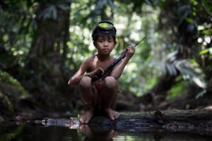 Chris Packham Instagram - Orang Rimba boy , Sumatra . Canon 5D SR , 70-200mm F4 . His name is Njarang . He lives in a shrinking parcel of forest where he runs free . He is part of that ecosystem , he hunts and gathers sustainably , he lives in complete harmony with that environment . The forest , his family , his lifestyle and culture are all critically endangered . He is one of the last truly beautiful humans on earth . ‘Chris Packham : In Search of the Lost Girl’ , tonight on BBC2 at 9pm . #orangrimba #sumatra #palmoil #palmoilfee #canon #canonphotography #canonuk #photography #photooftheday
