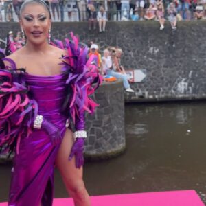 Courtney Act Instagram - What a glorious pride you have, Amsterdam! Thank you for a magical day and thank you to @missenvyperu and @rtl.nl for having me. 

The parade happens on the canal, the pride floats literally float down the water as hundreds of thousands of people cheer from the shore. There are about 26 bridges along the route which, as you will see in these videos, every few minutes everyone has to duck to avoid decapitation, the inflatables have come down, and then we emerge out the side to new crowd of people. Such a fun and unique pride parade! 

Looking forward to performing and hosting The Dam Stage today for the Closing Party! #amsterdampride