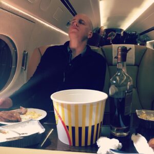 David Costabile Instagram - The making of Chickentown. Damian proudly pointing to the Axe Cap jet is rudely upstaged by director @neil.burger. Myself and  @kellyaucoin77 stuffing ourselves with fried bird and bourbon in this case @michterswhiskey 20 yr old bourbon. The only way to fly. Don’t miss this episode. #bts @sho_billions #wags #teamwags #wagsismyspiritanimal