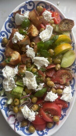 Dina Deleasa Instagram - Listen to me ramble about my favorite Panzanella Salad! That is because I love tomatoes so very much! The dressing is always very vinegar heavy and the crusty bread soaks it up.

Below is a recipe for the vinaigrette I used. I sliced 4 heirloom tomatoes, different colors. Along with one cucumber, thinly sliced red onion, and 3 cups of bread cubes. Then I sprinkled in about 1/2 cup of green olives, and topped it off with some torn buffalo mozzarella. Then tossed it all in the dressing below!

I would love to know how YOU make your Panzanella salad! 

PS- do you hear this Tomato song in the background?!! I think it will be my new anthem !!!

1/2 cup olive oil
3 tbsps red wine vinegar or white wine vinegar
1 1/2 tbsp finely chopped garlic
1/4 cup chopped fresh basil
1 tsp kosher salt
1/2 tsp pepper

#dishitgirl #tomatoseason #panzanella #summersalads #easyrecipe #healthyfood #summerrecipes #italiansummer