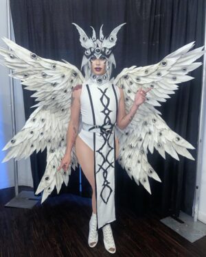 Dollya Black Instagram - 👁️👁️👁️Be not afraid 👁️👁️👁️
Earlier this year, I received a beautiful addition to my back tattoo from my friend, Gray. While cutting out the stencils for the tattoo, I was inspired to create a headpiece. Shoutout to @especimengris @especimenscythe for designing this headpiece for me. Everything you see, minus the garment, was made from EVA foam. I took the headpiece and deconstructed it to make a belt, choker, and panel down the front of my costume. I hand sculpted the eyes out of EVA Foam Clay. The wings were purchased, but painted/aged by me. I cannot express how much fun it was to take a design from my friend and bring it to life in this way. Collaborating as artists can be so rewarding. Thank you Gray for continuously inspiring me with your art. If you are in Los Angeles and need any tattoo work, please hit up @especimengris 💚
Thank you @epsuncitypride for having me this last weekend and giving me a platform to share this look.
Headpiece design: @especimengris @especimenscythe 
Wings: @lamurflowerswings painted by me
Eyes: Hand sculpted by me with the help of @venusenvydrag and @jrbryant101