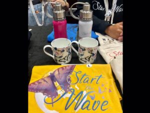 Dominique Provost-Chalkley Instagram - To all EhCon attendees… Please make sure to head by our @start_the_wave booth today for your final chance to get a STW Eco Merch item and support our organisation!!! 
You will meet some of our amazing team and can ask all the questions you may have about what we do. Have a beautiful day! 🦋💙🌈 #startthewave #ehconcananda