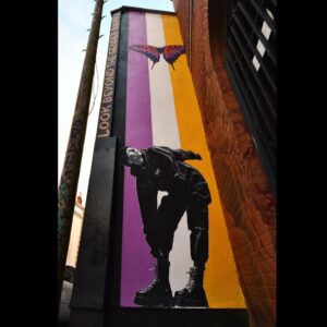 Dominique Provost-Chalkley Instagram - LOOK BEYOND THE GENDER BINARY 🖤💜🤍💛

Hillgrove street, Bristol. 

Thank you @zamzam__zz and @object000 and @peoplesrepublicofstokescroft for your stellar work on this piece. 🙏

My hope is that many non-binary folx feel seen and celebrated through each stroke of colour painted proudly on this wall. 

And to @falsepeak_ for taking the original photo of me! What a fun day of creativity we had running around the streets of Calgary :) 📸🖤

Here’s to non-binary thinking, to moving up and out of our heteronormative conditioning and to a world of freedom and exploration. 

Cheers Queers! 

Dom (they/them) 🦋

#PRSC #StarttheWave #STWcreativity #STWactivism #STWPride 🖤💜🤍💛