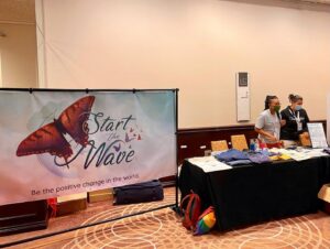 Dominique Provost-Chalkley Instagram - To all EhCon attendees… Please make sure to head by our @start_the_wave booth today for your final chance to get a STW Eco Merch item and support our organisation!!! 
You will meet some of our amazing team and can ask all the questions you may have about what we do. Have a beautiful day! 🦋💙🌈 #startthewave #ehconcananda