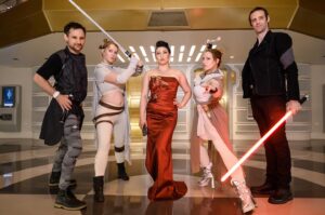 Erika Ishii Instagram - May the 4th be with you! Last year, my crew and I booked passage on the Star Cruiser Halcyon. It was a transcendent immersive experience and immensely inspired me in my storytelling. Thank you @car0mur for introducing us to the colorful characters onboard, and to the cast and crew who made our stay unforgettable. My friends and I boarded with elaborate backstories and costumes and every person aboard met us at our level and helped us live out our dreams on a galaxy far, far away. ♥️

Meet the motley crew of the Arabesque, a humble merchant ship that can help acquire anything you need.  Our pilot always said, “She doesn’t look like much, but out there in the stars, she dances.” I was Captain Lane Vizla (I borrowed the name of the SWTOR character I voice!) Socialite and pulp holo-vid actor by day, and by night a scoundrel using social connections to aid the Resistance. I hand painted my gown with Aurabesh: JUSTICE, TRUTH, LOVE.

Also today I can announce another new credit in a Star War: I’m a friendly Scoundrel/Smuggler in LEGO Fortnite!