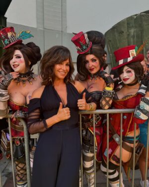 Gina Gershon Instagram - Such a treat to hang with me and my Moxxi’s at the Borderlands premiere tonight. Such an honor to go the the Chinese theatre with friends I have made to celebrate a movie we have made
Together. And always Love wearing my @lisaeisnerjewelry !!!!! Really makes an outfit! Thanks Lisa! And thanks @zacposen for my forever favorite suit!  Thank you so much! This movie is so crazy and fun to see ilon the big scene! Opens this week on august 9 th!!! @borderlandsfilm #moxxiforever