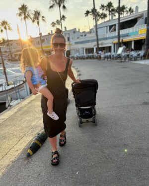 Helen Skelton Instagram - When the year old doesn’t get a shot at her own pram….. 
and the cute outfits I got for them are overlooked for a bargain bulk buy of last years Menorca merch…..
Just over here picking my battles.❤️😍🤪
#memories #summer #holidays