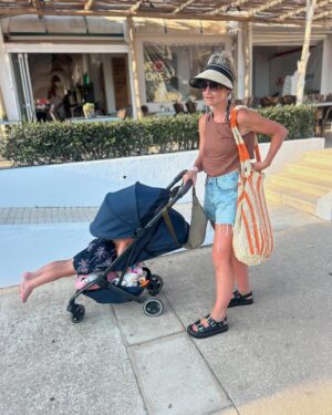 Helen Skelton Instagram - When the year old doesn’t get a shot at her own pram….. 
and the cute outfits I got for them are overlooked for a bargain bulk buy of last years Menorca merch…..
Just over here picking my battles.❤️😍🤪
#memories #summer #holidays