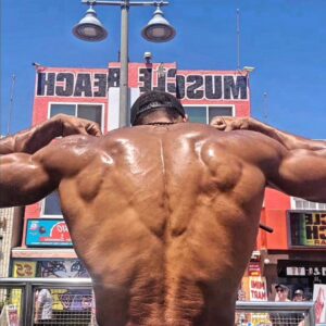 Ike Catcher Instagram - We Back like that! #biggestmanonthebars #back 
Spreading my lats like they are wings Sit in the sun  like im the sphinx #ikeCATcher #kingofmusclebeach