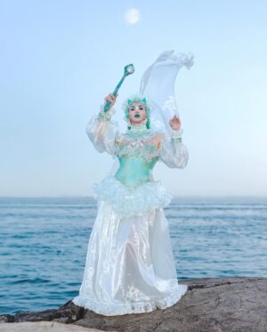 Ilona Verley Instagram - “I’ll bring thunder, I’ll bring rain”
🌊🌊🌊🌊
Happy rupaulsdragcon !!!
It is truly such an honour to be back in the drag race atmosphere after a couple years of distancing myself to do my own shadow work, learn how to be my favourite version of myself & be a force behind the scenes for my communities & my sisters!
🌊🌊🌊🌊
This look is inspired by the pearl look I created for @the.girlfriendexperience for S4 of @canadasdragrace , I wanted to mirror it with my own perspective of abalone (a very sacred part of my cultural practice)
I created this entire look from scratch over the last month!
Huge thank you to Kim from Chinatown for all your help embellishing & my drag mom @the.Alma.be for saving me with the last min details! 
🌊🌊🌊🌊
Makeup:
@sugarpillcosmetics
@aboutfacebeauty
@kvdbeauty
Photos:
@megsgiallo
Fantasy Edit:
@hulk_broghen 
Sceptre & harp:
@iron_andblood
🌊🌊🌊🌊
#oceanphotoshoot #seagodess #abalone #worbla #dragcon2024 #rupaulsdragcon #canadasdragrace #headpiece #fashiondesign #ostrich #seashells