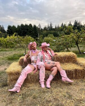 Ilona Verley Instagram - “Working 9-5, what a way to make a living”
💖💖💖💖
Had the most fabulous time working with @thegayagendaevents this past weekend for their 2nd annual Garden Party Tea Dance at the @ubcfarm 
💖💖💖💖
I’m a sucker for a good theme and the inspiration struck when @shashaxl_ and I found a beautiful white leather coat at @stoxxvintage that I knew was going to become a fab look, however it was too big on me so as I took it in and realized how much excess leather there was going to be I asked @hulk_broghen if he would be down to do a matching look with me and the two of us then worked together to use the remnants and materials I had around the studio to bring our matching cowboy/cowgirl looks to life and combine our worlds to create something completely unique and out of the box that would bring a visual aspect of our vibes to the FUNCTION!
💖💖💖💖
Thank you to @thegayagendaevents for having us be apart, it was a BLAST!
Shout out to @nudebeverages for having the perfect drinks on hand to match the PINK energy we were giving!
@lonsdaleleather for the hardware and the leather paint that made the pink-ification of the iconic white leather coat that provided these looks possible!
And our fierce friends and photographers for capturing these moments! 
3rd photo by: @aleemkassam 
4th photo by: @japantara 
5th photo by: milesmead0ws 
6th photo by: @mx.jiggityjeff 
7th photo by: @kylson92 
💖💖💖💖
#labourday #laborday #wildwest #cowboy #cowgirl #fashion #costumeparty #drag #dragqueen #pinkhue #pinkhair #pinkcowboyhat #leatherwork #leathercoat #leatherfashion #upcycle