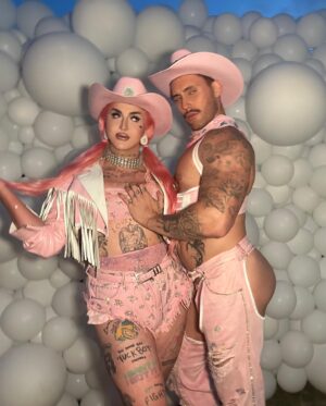 Ilona Verley Instagram - “Working 9-5, what a way to make a living”
💖💖💖💖
Had the most fabulous time working with @thegayagendaevents this past weekend for their 2nd annual Garden Party Tea Dance at the @ubcfarm 
💖💖💖💖
I’m a sucker for a good theme and the inspiration struck when @shashaxl_ and I found a beautiful white leather coat at @stoxxvintage that I knew was going to become a fab look, however it was too big on me so as I took it in and realized how much excess leather there was going to be I asked @hulk_broghen if he would be down to do a matching look with me and the two of us then worked together to use the remnants and materials I had around the studio to bring our matching cowboy/cowgirl looks to life and combine our worlds to create something completely unique and out of the box that would bring a visual aspect of our vibes to the FUNCTION!
💖💖💖💖
Thank you to @thegayagendaevents for having us be apart, it was a BLAST!
Shout out to @nudebeverages for having the perfect drinks on hand to match the PINK energy we were giving!
@lonsdaleleather for the hardware and the leather paint that made the pink-ification of the iconic white leather coat that provided these looks possible!
And our fierce friends and photographers for capturing these moments! 
3rd photo by: @aleemkassam 
4th photo by: @japantara 
5th photo by: milesmead0ws 
6th photo by: @mx.jiggityjeff 
7th photo by: @kylson92 
💖💖💖💖
#labourday #laborday #wildwest #cowboy #cowgirl #fashion #costumeparty #drag #dragqueen #pinkhue #pinkhair #pinkcowboyhat #leatherwork #leathercoat #leatherfashion #upcycle