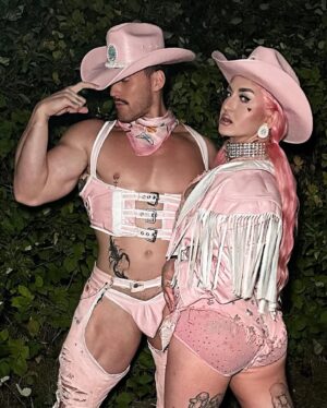 Ilona Verley Instagram - “Working 9-5, what a way to make a living”
💖💖💖💖
Had the most fabulous time working with @thegayagendaevents this past weekend for their 2nd annual Garden Party Tea Dance at the @ubcfarm 
💖💖💖💖
I’m a sucker for a good theme and the inspiration struck when @shashaxl_ and I found a beautiful white leather coat at @stoxxvintage that I knew was going to become a fab look, however it was too big on me so as I took it in and realized how much excess leather there was going to be I asked @hulk_broghen if he would be down to do a matching look with me and the two of us then worked together to use the remnants and materials I had around the studio to bring our matching cowboy/cowgirl looks to life and combine our worlds to create something completely unique and out of the box that would bring a visual aspect of our vibes to the FUNCTION!
💖💖💖💖
Thank you to @thegayagendaevents for having us be apart, it was a BLAST!
Shout out to @nudebeverages for having the perfect drinks on hand to match the PINK energy we were giving!
@lonsdaleleather for the hardware and the leather paint that made the pink-ification of the iconic white leather coat that provided these looks possible!
And our fierce friends and photographers for capturing these moments! 
3rd photo by: @aleemkassam 
4th photo by: @japantara 
5th photo by: milesmead0ws 
6th photo by: @mx.jiggityjeff 
7th photo by: @kylson92 
💖💖💖💖
#labourday #laborday #wildwest #cowboy #cowgirl #fashion #costumeparty #drag #dragqueen #pinkhue #pinkhair #pinkcowboyhat #leatherwork #leathercoat #leatherfashion #upcycle