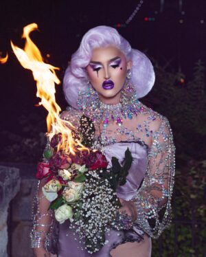 Ilona Verley Instagram - “Not everybody lives, but everybody dies”
🥀🥀🥀🥀
It’s been what, 3 years since CDR S1?
And I’m JUST NOW finishing posting all the photos from that era in my life…
I deleted / archived everything from drag race shortly after the show aired because I had such a tumultuous relationship with CDR and my experience that the photos and the looks from that era were things that hurt me…
When I started healing my relationship with myself and ultimately that experience, I started to feel more comfortable with the photos and been trying to repost them, but as we all have seen my feed aesthetic has made that hard and controls the way I have been posting…
ANYWAYS, finally my elimination photo is back on my feed and I can end this era on a happier note this time around
🥀🥀🥀🥀
Last slide is my original credits and caption from the first time this photo went up
🥀🥀🥀🥀
Photos and original edit @thedragseries 
Updated edit: meee
Shoot assistant: @japantara 
Hair: @awesomebitchwig 
Dress originally by @ms_misty_meadows modified by myself and Steph
Jewelry by that one Pidge company 
🥀🥀🥀🥀
#canadasdragrace @canadasdragrace #cdr #ilonaverley #purplehair #draghair #dragwig #pageanthair #gown #lavender #firephotography #opulence