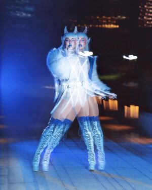 Ilona Verley Instagram - “DEMI-DEVIL, DEMON, LITTLE GARGOYLE GIRL, EVERYBODY’S BLEEDING ON THE MARBLE FLOOR”
😈😈😈😈
This past week @ashnikko ‘s Demi-Devil Mixtape celebrated its first bday!!!
So for this weeks #throwbackthursday I knew I had to revisit this Ashnikko / Demi-Devil inspired fantasy I did in honour of the mixtape release this time last year!
😈😈😈😈
Y’all know I have so much love for Ashnikko, She really carved out a niche in music that was so needed, and is constantly inspiring me with her open hearted bad assery!!!
IM SO STOKED TO SEE WHAT SHES GONNA DROP NEXT!!!! (Love u sis!)
😈😈😈😈
Photos by: The Drag Series
Assist @badd.gyal.cleo 
Jacket & Harness by @evanclayton 
Boots, bodysuit and horns by me!
😈😈😈😈
#demidevil #ashnikko #drag #devilmakeup #trippymakeup #bluehair #thighhighboots