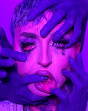 Ilona Verley Instagram - “you don't wanna be changed like it changed me”
✨✨✨✨
TW: Mental Health 
✨✨✨✨
A few years ago I had the idea to do a shoot with colored hands pulling at my face, it was a visual representation of the barriers I face living with OCD. (Swipe to see my OG post that has long been archived…)
When @iiswhoiis dropper the visuals for eat the acid I was so stoked to see her also having a similar concept to suuuuch a powerful song that I felt so much of my own journey in. Great minds think alike and all that! 
As soon as I saw her visuals I knew I wanted to give this concept another shot! 
✨✨✨✨
I’ve been re-navigating a lot of my barriers with my OCD the last few months and coming up with healthier coping skills, re learning what a healthy relationship looks like with my mental health and limiting myself less.
✨✨✨✨
Eyes:
@suvabeauty UV Brights palette
@litcosmetics Party Girl Glitter mix
Brows:
@anastasiabeverlyhills Ebony Dip Brow
Lips:
@maybelline Super Stay Matte Ink in Mover
@limecrimemakeup Mermaids Hi-Lite palette 
✨✨✨✨
Thank you to @hulk_broghen & @coco_klein for being my hands 
Thank you to @megsgiallo for shooting 
Thank you to everyone including mom ( @sandiverley )for helping with the Lighting 
✨✨✨✨
#eattheacid #kesha #hands #meantalhealth #ocd #bodypaint #creativelhotography #teamwork #purple #drag #canadasdragrace