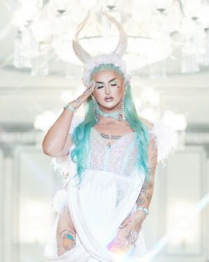 Ilona Verley Instagram - “Fallen Angel, you want me to be done”
✨✨✨✨
The last couple months I’ve found myself going over my experience with @worldofwonder and thinking about how I let the actions of a handful of people shape my view on something I once loved.
I wouldn’t be the out and proud queer trans person I am today if I had never found @rupaulsdragrace …
When we filmed in 2019 I was lost and scared and thought that the show was going to save me and fix all of my problems, I projected my insecurities onto the experience thinking it was going to change my life instead of seeing that I was and still am the only person that I need to change my life, it’s not someone else’s responsibility.
This year I’m moving forward with that mentality, everything I want and I need I’m going to work towards and make happen myself with out relying on other people or experiences in an unhealthy way to get me to where I want to be! Of course we all need our support networks and I am beyond thankful for mine, but I’m not going to rely on them more than I rely on myself & am going to hold myself accountable for keeping healthier relationships going forward!
✨✨✨✨
Hair & photos by The Drag Series
Assisted by @kelsifer888
Look designed by myself & @evanclayton
Made by @rosegoldblunt
Horns by that girl I blocked ‘s boyfriend & @theonethatsugly
Location: @fairmontvan 
Leather: @creepyyeha
Shoes, wraps & ears by me!
✨✨✨✨
#canadasdragrace #dragrace #drag #mintgreenhair #elfears #euphoriamakeup