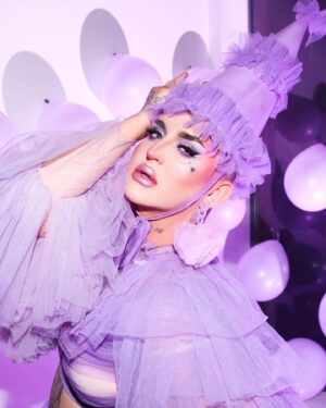 Ilona Verley Instagram - “Maybe if I knew all of them well,
I wouldn't have been trapped inside this hell that holds me”
💜💜💜💜
I survived the 27 club!
As silly as it may seem it’s always been something that has haunted me, 7’s and death have been prominent in my life and the whole concept of the 27 club had me feeling ANXIOUS this past year if we r being REAL!
💜💜💜💜
I’m now going into the last couple years of my 20’s feeling secure in the version of myself I am now and feeling a lot of clarity around my relationships and what I am able to bring to the table in terms of self identity and accountability.
I’m truly feeling free and truly feeling happy.
I’m so close to the person i used to fantasize about being, my dreams are slowly becoming my reality and that is the best birthday present I could ever ask for!
💜💜💜💜
Photos: @allthatbeth_
Ruffled coat : @evanclayton 
Matching accessories: by me 
Earrings: @vexdesigns.ca
Nails: @kissproducts
💜💜💜💜
Face:
@kryolanofficial paint sticks NB2 & TV White
@rcmamakeup colourless powder
@kvdbeauty Contour palettes 
@limecrimemakeup hi-lite mermaids palette
Eyes:
@colourpopcosmetics Fade Into Hue palette
@litcosmetics Party Girl Glitter
@limecrimemakeup Liquid Liner in Baby’s Breath & Black
Lips:
@kvdbeauty Lolita 
 
@limecrimemakeup Hi-lite Mermaids over top
Brows:
@kvdbeauty Medium Brown pomade 
💜💜💜💜
#dragqueen #drag #purplemakeup #glittereyes #glittermakeup #graphicliner #limecrime #kvdbeauty #canadasdragrace #lavenderhaze