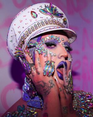 Ilona Verley Instagram - "I'm on everyone's radar
I bet that's why they hate her"
💎💎💎💎
The first time I remember being so inspired that it shaped me as a human was witnessing @brookecandy 's Opulence era unfold in real time.
I was just getting into drag at the time and to this day those looks and that song have had such a grip on me and my aesthetic!
Over the years I've recreated various looks from Brooke's Opulence era, always wishing I had the resources to do them better.
I sat down this week and revisited the OG inspo, the @papermagazine cover and was able to bring my interpretation to life in a way I can finally say I am so proud of! 
If you swipe to the end you'll see the first time I ever tried to take on that look... I was 20 years old, had some dollar store rhinestones and a DREAM. 
💎💎💎💎
Hat by me! 
Jewelry is all left over shit from my drag race package 
Head wrap was made by @evanclayton
Photos by @the.Alma.be
Nails are @kissproducts
💎💎💎💎
#dragrace #ilonaverley #drag #brookecandy #opulence #festivalfashion #festivalmakeup #creativemakeup #ABcrystal