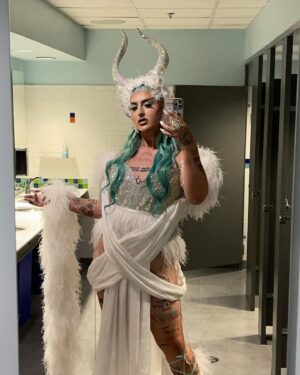 Ilona Verley Instagram - “Fallen Angel, you want me to be done”
✨✨✨✨
The last couple months I’ve found myself going over my experience with @worldofwonder and thinking about how I let the actions of a handful of people shape my view on something I once loved.
I wouldn’t be the out and proud queer trans person I am today if I had never found @rupaulsdragrace …
When we filmed in 2019 I was lost and scared and thought that the show was going to save me and fix all of my problems, I projected my insecurities onto the experience thinking it was going to change my life instead of seeing that I was and still am the only person that I need to change my life, it’s not someone else’s responsibility.
This year I’m moving forward with that mentality, everything I want and I need I’m going to work towards and make happen myself with out relying on other people or experiences in an unhealthy way to get me to where I want to be! Of course we all need our support networks and I am beyond thankful for mine, but I’m not going to rely on them more than I rely on myself & am going to hold myself accountable for keeping healthier relationships going forward!
✨✨✨✨
Hair & photos by The Drag Series
Assisted by @kelsifer888
Look designed by myself & @evanclayton
Made by @rosegoldblunt
Horns by that girl I blocked ‘s boyfriend & @theonethatsugly
Location: @fairmontvan 
Leather: @creepyyeha
Shoes, wraps & ears by me!
✨✨✨✨
#canadasdragrace #dragrace #drag #mintgreenhair #elfears #euphoriamakeup