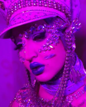 Ilona Verley Instagram - "I'm on everyone's radar
I bet that's why they hate her"
💎💎💎💎
The first time I remember being so inspired that it shaped me as a human was witnessing @brookecandy 's Opulence era unfold in real time.
I was just getting into drag at the time and to this day those looks and that song have had such a grip on me and my aesthetic!
Over the years I've recreated various looks from Brooke's Opulence era, always wishing I had the resources to do them better.
I sat down this week and revisited the OG inspo, the @papermagazine cover and was able to bring my interpretation to life in a way I can finally say I am so proud of! 
If you swipe to the end you'll see the first time I ever tried to take on that look... I was 20 years old, had some dollar store rhinestones and a DREAM. 
💎💎💎💎
Hat by me! 
Jewelry is all left over shit from my drag race package 
Head wrap was made by @evanclayton
Photos by @the.Alma.be
Nails are @kissproducts
💎💎💎💎
#dragrace #ilonaverley #drag #brookecandy #opulence #festivalfashion #festivalmakeup #creativemakeup #ABcrystal