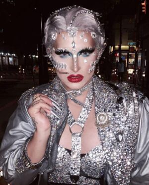 Ilona Verley Instagram - "I'm on everyone's radar
I bet that's why they hate her"
💎💎💎💎
The first time I remember being so inspired that it shaped me as a human was witnessing @brookecandy 's Opulence era unfold in real time.
I was just getting into drag at the time and to this day those looks and that song have had such a grip on me and my aesthetic!
Over the years I've recreated various looks from Brooke's Opulence era, always wishing I had the resources to do them better.
I sat down this week and revisited the OG inspo, the @papermagazine cover and was able to bring my interpretation to life in a way I can finally say I am so proud of! 
If you swipe to the end you'll see the first time I ever tried to take on that look... I was 20 years old, had some dollar store rhinestones and a DREAM. 
💎💎💎💎
Hat by me! 
Jewelry is all left over shit from my drag race package 
Head wrap was made by @evanclayton
Photos by @the.Alma.be
Nails are @kissproducts
💎💎💎💎
#dragrace #ilonaverley #drag #brookecandy #opulence #festivalfashion #festivalmakeup #creativemakeup #ABcrystal