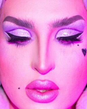 Ilona Verley Instagram - “Life of the party, but the party is finally over”
✨✨✨✨
HELLO INSTAGRAM!
I am so beyond excited to officially announce my new collaboration with @litcosmetics welcome to the stage PARTY GIRL glitter mix!
I wanted to create a shade that was true to my pastel brand & missing from my current glitter collection! 
Party Girl is a mix of different sized glitter to maximize sparkle with a lavender base ranging in holographic / indecent hues to tie into all the fun pastel colors I’m known for serving!
This is my absolute dream shade of glitter & I am looking forward to seeing all the looks you guys create with it! Make sure you hashtag #litcosmeticspartygirl so I can find all your fabulous serves!
✨✨✨✨
PS!!!
Use code ilonaverley-lit20 to save 20% off your entire order when you check out in the @litcosmetics website!!!
✨✨✨✨
Huge thank you to Jodie and everyone at Lit for always supporting my art and showcasing my talent long before I ever made it on tv! 
LOVE YALL SO MUCH!
✨✨✨✨
Couldn’t have put this project together with out the following fabulous friends! So if you like this look and these photos please show some love to the following::::
Photos @megsgiallo 
PARTY GIRL logo also by Meg!
Beaded earrings by @sadndn_ 
Assisted by @theevascarlett 
Big thank you to @numberscabaret for letting us in to shoot in their fab space!
Hair colored and styled by me! 
✨✨✨✨
#drag #instadrag #purplemakeup #purpleglitter #litcosmetics #partygirl #humanhairwig #crimpedhair #trans #browlamination #ilonaverley #canadasdragrace