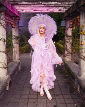Ilona Verley Instagram - “I’ve got my own little magic | I’m not tryna wreak havoc”
🕊️🕊️🕊️🕊️
Flashback Friday to this fabulous look my incredible friends at @jackalopeland created for me a couple years back!
We shot this during the lockdowns in the middle of winter, the weather lately has had me reminiscing about that day! 
As always still playing catch up with my feed, trying to get the last few archived photos back out into the world before I start my next era of posting more frequently/ posting things I’m actually doing. I feel like I’ve been in such a rut since Drag Race as far as what I’m posting but I still feel the need to pay tribute that era of my life…
🕊️🕊️🕊️🕊️
Photo by @poutine_queen 
Look by @jackalopeland 
Hair by @ardawigscanada 
Boots were @sparklfashion thigh highs that i chopped up 😅✨
🕊️🕊️🕊️🕊️
#drag #dragqueen #purplehair #witchfashion #pastelwitch #witchyvibes #witchhat #bighat #purplehat #trans