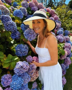 Jane Seymour Instagram - There’s something deeply comforting in the way hydrangeas flourish with such grace, each bloom a testament to the beauty of slow, steady growth. 🪴⁣
⁣
As I stand among them, I’m reminded most of life’s most precious moments often come from simply being present. These blossoms remind me to take a step back, to breathe, and to find peace in the rhythm of nature. ⁣
⁣
In a world that’s always rushing, may we all find the courage to slow down and appreciate the quiet miracles unfolding around us. ⁣
⁣
Today, I choose to bloom gently, to embrace the serenity in simplicity, and to find joy in the gentle sway of the seasons. 💜 Will you join me?