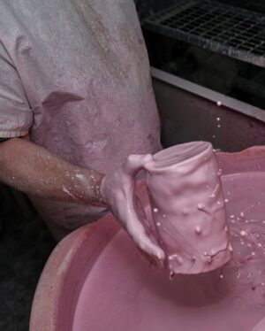 Joe Lycett Instagram - Back in October last year I went along to @duchesschina1888 in Stoke-on-Trent to see how they were getting on with the Slags Vase. It’s a very special sprawling place, steeped in history and so much love for ceramics and their production. I was fortune to meet Gordon who is their master modeller, whose job it was to measure up my original piece-of-shit design and recreate it in bone china. I’d like to apologise to Gordon for making him stoop so low as to recreate my vase. I also got to see their production line and some of the other work they do for the royals, amongst others, and make a mug, which I’m pretty sure I watched someone immediately put into a bin. 

It was a total delight working with Gordon, Jason and the team on this project, all beautifully coordinated by @theymadethistagram 

The limited edition vases (only 250 made) go on sale to my mailing list tomorrow morning and all the money I make from the sales will go to @artsemergency. Sign up at joelycett.com
