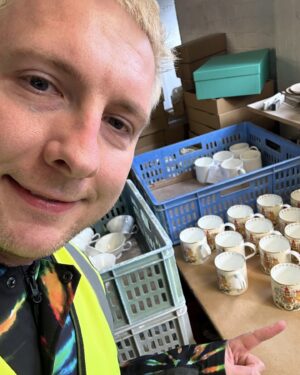 Joe Lycett Instagram - Back in October last year I went along to @duchesschina1888 in Stoke-on-Trent to see how they were getting on with the Slags Vase. It’s a very special sprawling place, steeped in history and so much love for ceramics and their production. I was fortune to meet Gordon who is their master modeller, whose job it was to measure up my original piece-of-shit design and recreate it in bone china. I’d like to apologise to Gordon for making him stoop so low as to recreate my vase. I also got to see their production line and some of the other work they do for the royals, amongst others, and make a mug, which I’m pretty sure I watched someone immediately put into a bin. 

It was a total delight working with Gordon, Jason and the team on this project, all beautifully coordinated by @theymadethistagram 

The limited edition vases (only 250 made) go on sale to my mailing list tomorrow morning and all the money I make from the sales will go to @artsemergency. Sign up at joelycett.com